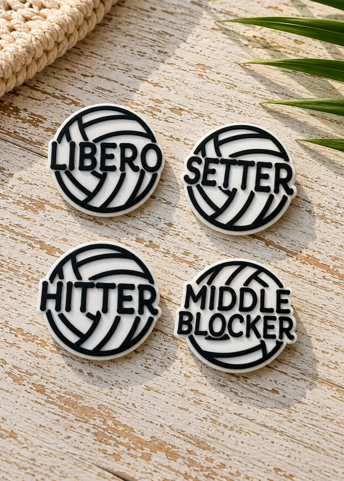 Four round white and black volleyball-themed croc or shoe charms, labeled LIBERO, SETTER, HITTER, and MIDDLE BLOCKER.