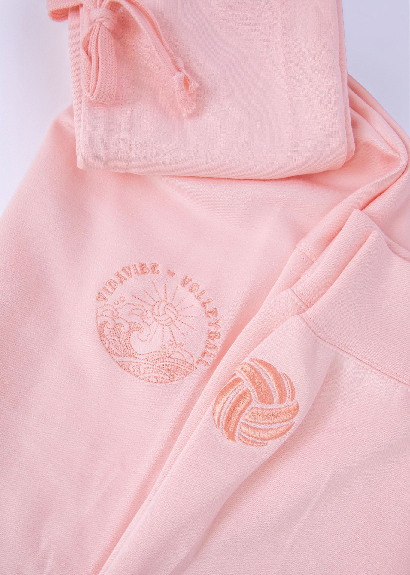 Pink Volleyball Hoodie Front with volleyball on the sleeve