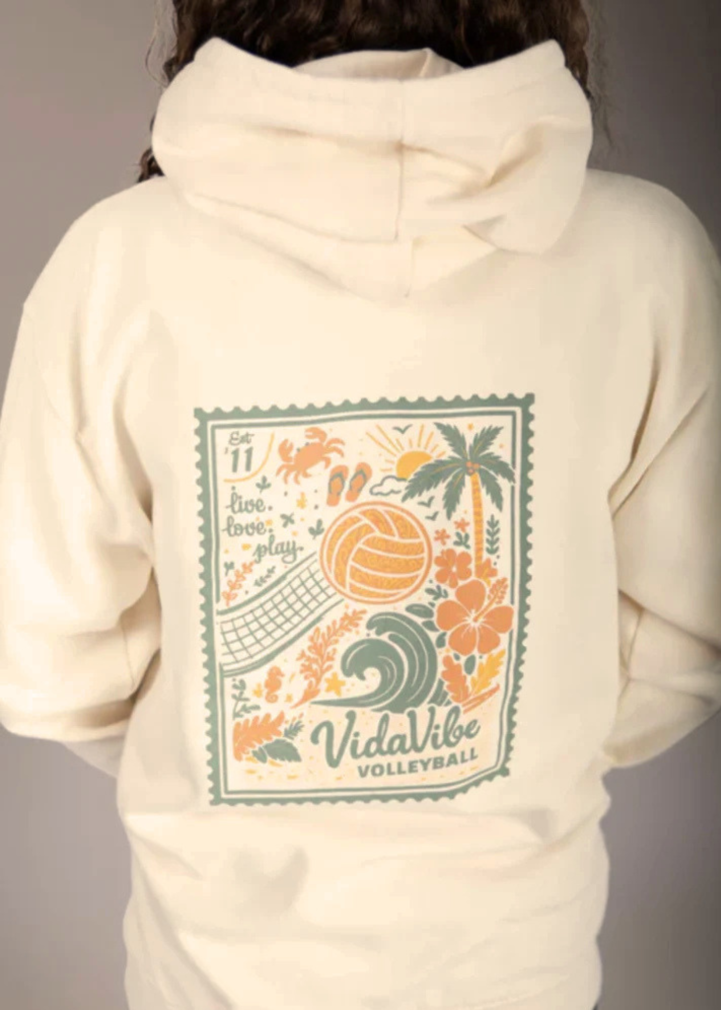 Beige hoodie with a colorful graphic and 'VidaVibe Volleyball' text on the back.