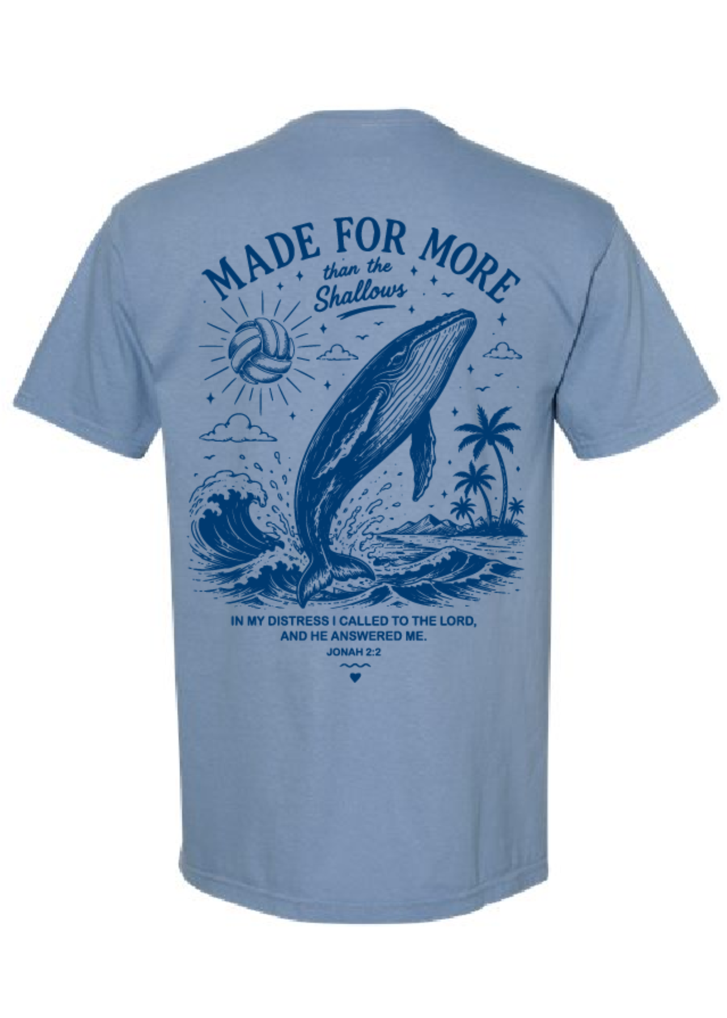 A light blue short-sleeve t-shirt shown from the back, featuring a large dark blue graphic print of a whale jumping out of water with a volleyball, palm trees, and a Bible verse.