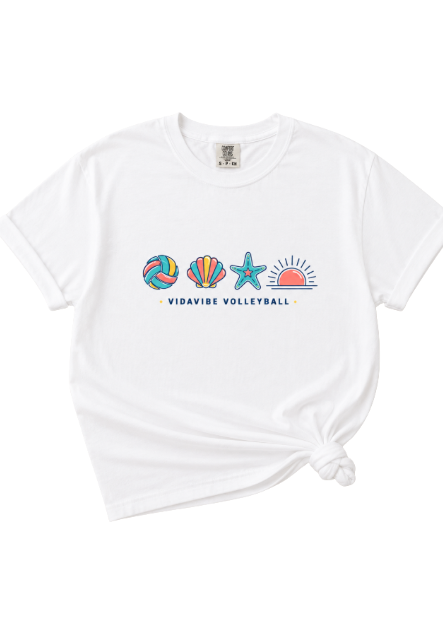 A white short-sleeve t-shirt with a colorful beach-themed graphic on the chest featuring a volleyball, seashell, starfish, and sun, with the text 'VIDAVIBE VOLLEYBALL'. The t-shirt is styled with a knot at the bottom right, set against a plain white background.