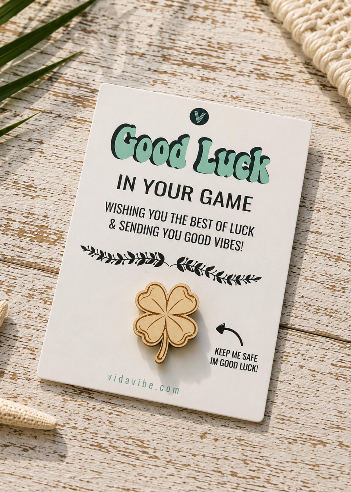 pinback button featuring a gold four-leaf clover, mounted on a white display card with the text 'Good Luck IN YOUR GAME'.