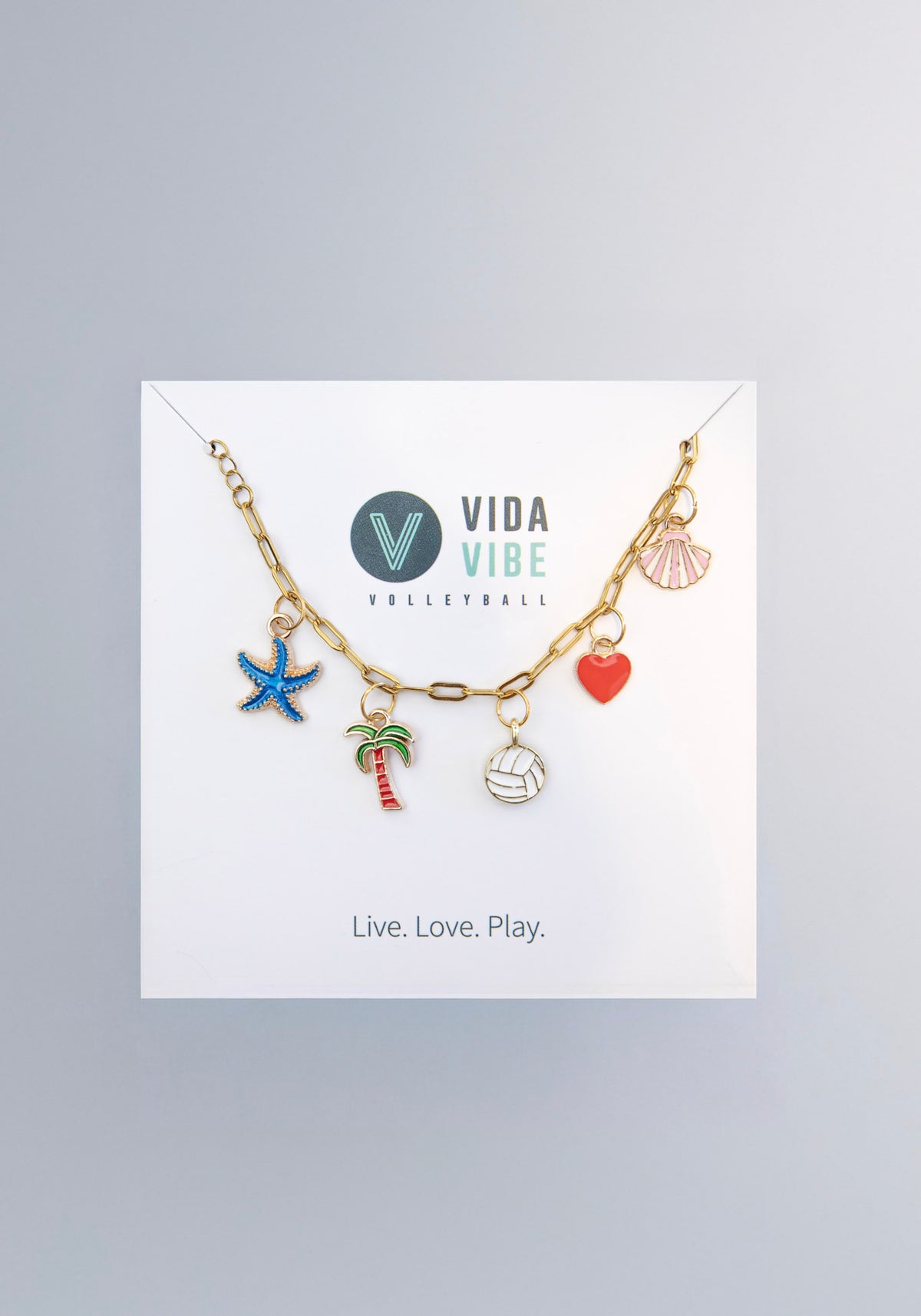 Bracelet with beach-themed charms on a Vida Vibe Volleyball branded card